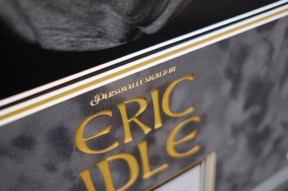 Monty Python Star Eric Idle signed white card display - Memorabilia Framers Shop
